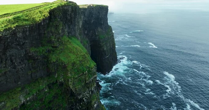 Flying Over Rocky Coastline alongside Cliffside with Blue North Atlantic Ocean