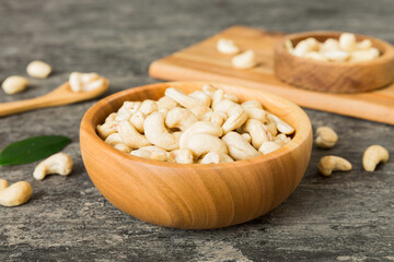 Fototapeta na wymiar cashew nuts in wooden bowl on table background. top view. Space for text Healthy food