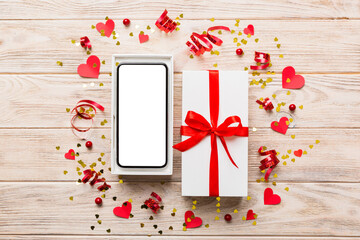 Opened gift box with ribbon and phone on color background, top view. Blank open box packaging mockup , Template for your design - branding mockup