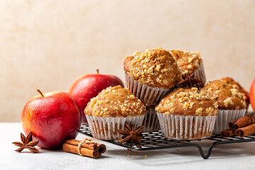 Cinnamon streusel apple muffins or mini cakes on a baking tray. Homemade bakery. Fresh red apples....