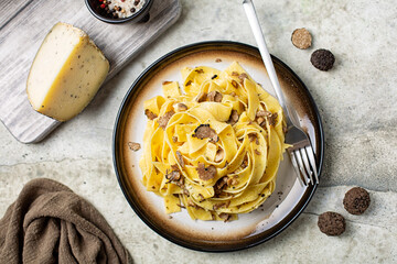 Top view of truffle fettuccine with mushrooms, long egg pasta. Italian first course made with hard cheese and butter. Ingredients. - obrazy, fototapety, plakaty