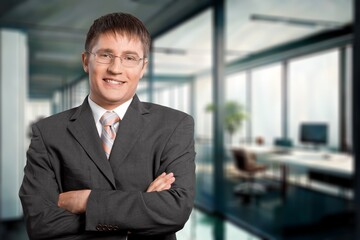 Happy confident business man professional with arms crossed