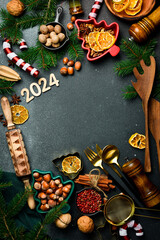 Baking flour and number 2024 on blackboard. Top view. New year food background. Christmas decorations, gifts, fir trees. Top view. Flat lay.