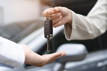 transportation rental automotive business concept. Close up hands of rental auto agent giving car...