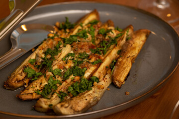 Baked eggplant with garlic, nuts and herbs