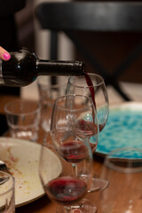 Fototapeta na wymiar Sommelier pours red wine into a glass during tasting