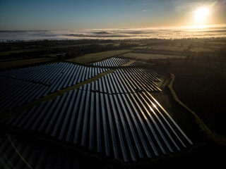 Drone aerial view of a solar farm at sunrise