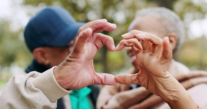 Senior, love and couple heart hands for trust, support and care together in outdoor forest, park or nature. Morning, man and elderly woman on retirement holiday or vacation in the woods for romance
