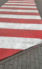 Red and white zebra on the street. Crosswalk.
