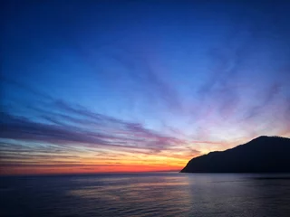 Foto auf Glas sunset over the sea © Federica Ravettino