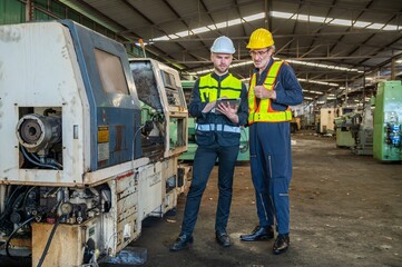 Two professional engineer worker technician checking old machine construction factory with colleague technician. factory assistant worker in helmet check old machinery construction in old factory.