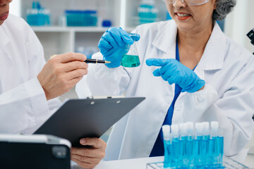 Scientist two woman with tablet and laptop, laboratory and ecofriendly science. Agriculture, research and scientists with online reading, test samples