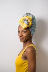 Portrait of beautiful happy young casual black woman wearing a headwrap. - 677633042