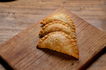 argentinian meal on wooden table empanadas