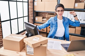 Young beautiful hispanic woman ecommerce business worker tired working at office