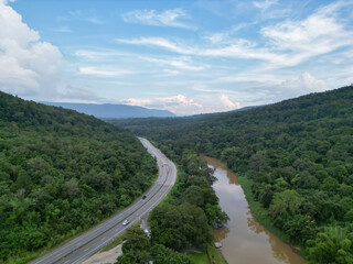 Aerial photography showing beautiful rivers and mountainside roads. Transportation concepts.