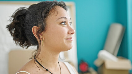 Young beautiful hispanic woman smiling confident looking to the side at new home