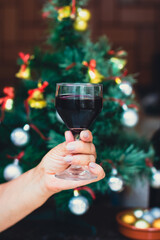 Holding a Wine Glass With Christmas tree at Yard Background