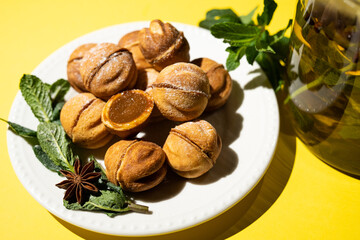 Homemade nut cookies with condensed milk on a yellow background.