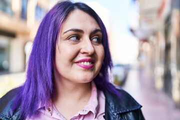 Young beautiful plus size woman smiling confident looking to the side at street