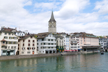 View of the historic city center with famous Saint Peter, on the Limmat river. Zurich, Switzerland.