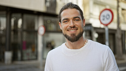 Young hispanic man smiling confident standing at street