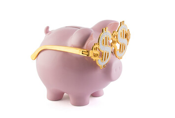 Pink piggy bank wearing golden glasses with dollar sign isolated on white background with clipping path