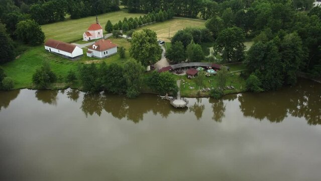 A small settlement with a chapel by the farm pond. Drone.