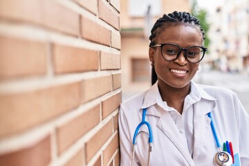African american woman doctor smiling confident standing at street