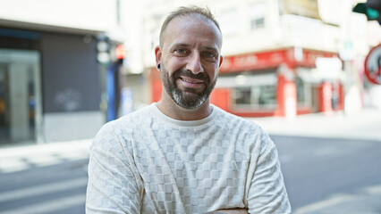 Cool, confident young man standing on street, smiling with joy - a glimpse of urban lifestyle, handsome caucasian adult embodying confidence, happiness and positivity, enjoying his city life.