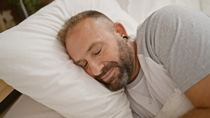 Exhausted young man enjoying cozy comfort, sleeping deeply on a soft bed in a relaxed morning scene...