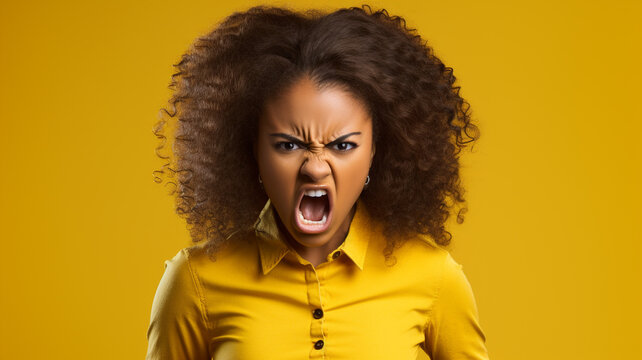 Angry irritated African American girl on yellow background