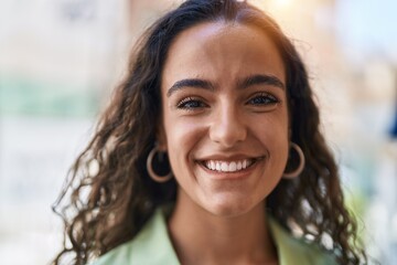 Fototapeta premium Young beautiful hispanic woman smiling confident standing at street