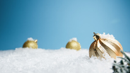 gold Christmas balls composition under the snow 