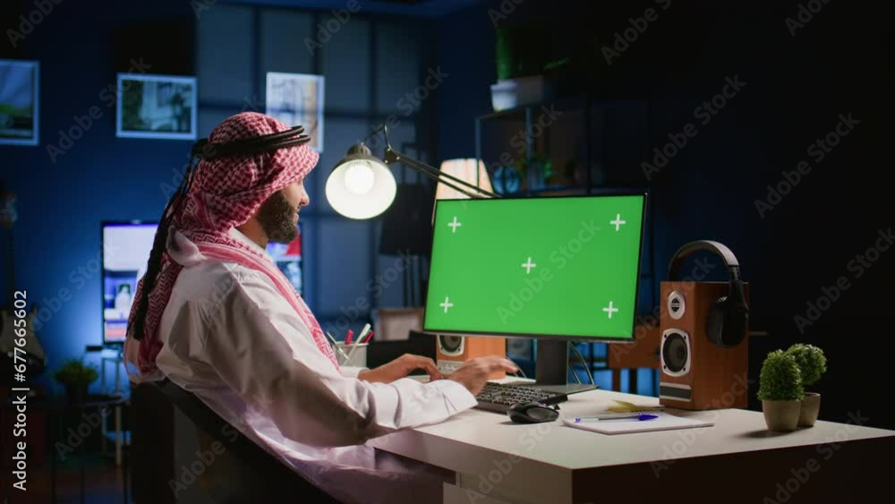 Poster arabic man looking at mockup computer screen while working from home. self employed person typing on