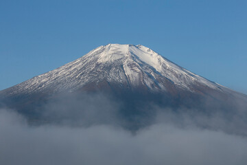 Views of the peak of Mount Fuji covered in snow in the city of Fujiyoshida in Japan.