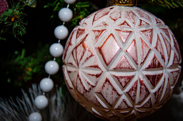 Christmas tree decoration. Decoration for New Year holiday celebration. Happy New Year. Christmas Tree Background. Beautiful Christmas gift near fir tree in room. Festive Christmas scene