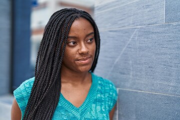 African american woman standing with relaxed expression at street