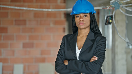African american woman architect standing with arms crossed gesture and serious expression at...