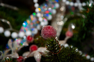 Christmas tree decoration. Decoration for New Year holiday celebration. Happy New Year. Christmas Tree Background. Beautiful Christmas gift near fir tree in room. Festive Christmas scene