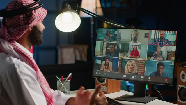 Arab man paying attention in webinar internet teleconference. Middle Eastern student in online videocall with tutor and other diverse multiethnic colleagues, listening to lesson