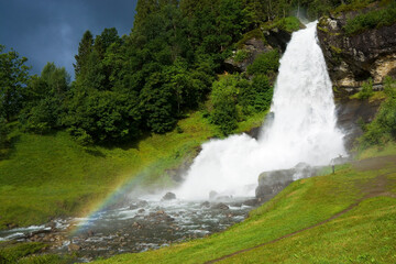 Steinsdalsfossen waterfall in the village of Steine, Norway - 677671253