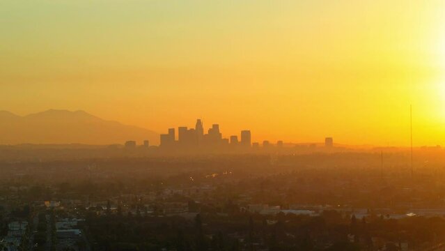 Aerial Upward Silhouette Of Financial District In City Against Orange Clear Sky During Sunset - Culver City, California