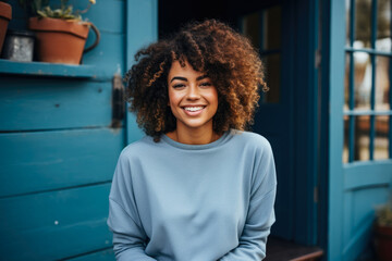 Fototapeta premium Urban Style: African American Woman in a Relaxed Pose in a Blue Sweater