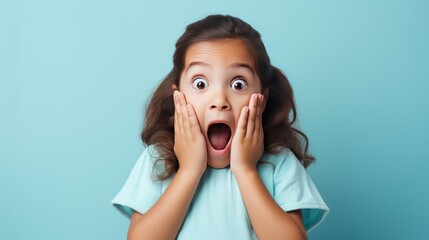 portrait of Shocked and surprised girl screaming covering mouth her hands. Light blue background.