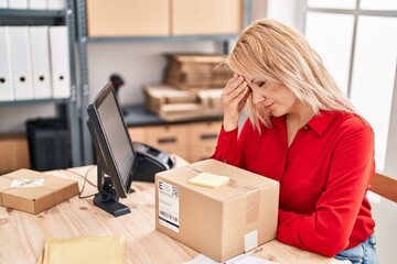 Young blonde woman ecommerce business worker stressed working at office