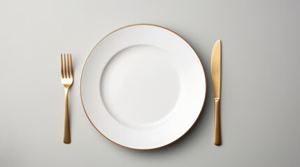 Top view of empty plate and gold cutlery on gray background,Details on the dining table