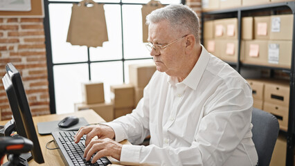 Fototapeta premium Middle age grey-haired man ecommerce business worker using computer at office