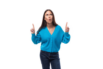 Fototapeta na wymiar charming caucasian woman with black hair is dressed in a blue sweater on a white background. people lightstyle concept