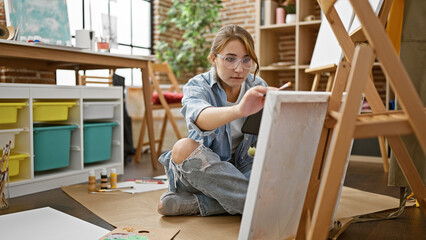 Young woman artist looking touchpad drawing at art studio